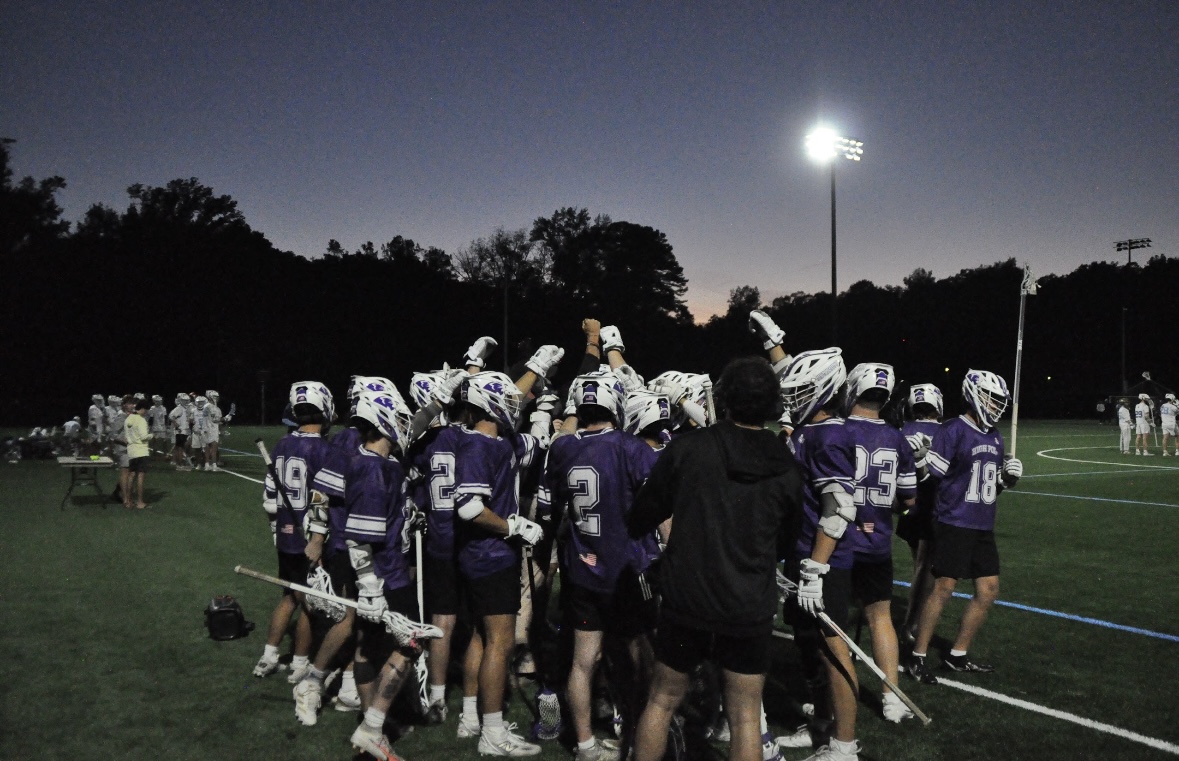 Team huddle under the lights