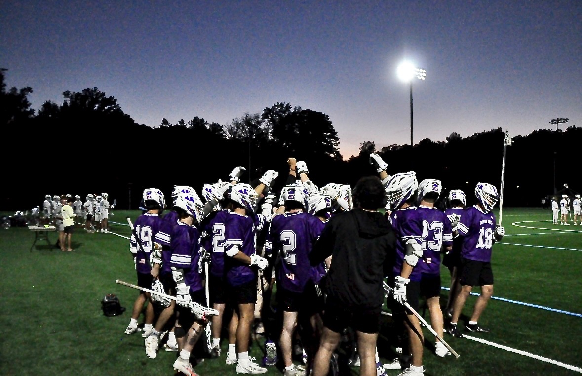 Team huddle under the lights